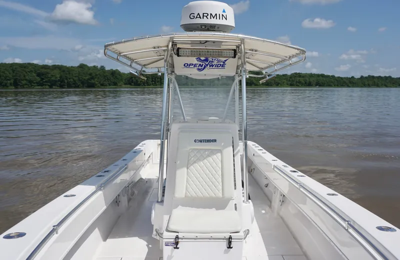  Yacht Photos Pics 2003 Contender 31 Open boat on calm water, featuring Garmin equipment and clear skies.