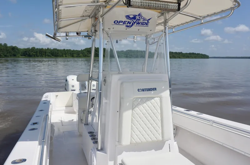  Yacht Photos Pics 2003 Contender 31 Open boat on calm water, featuring a spacious deck and dual engines.