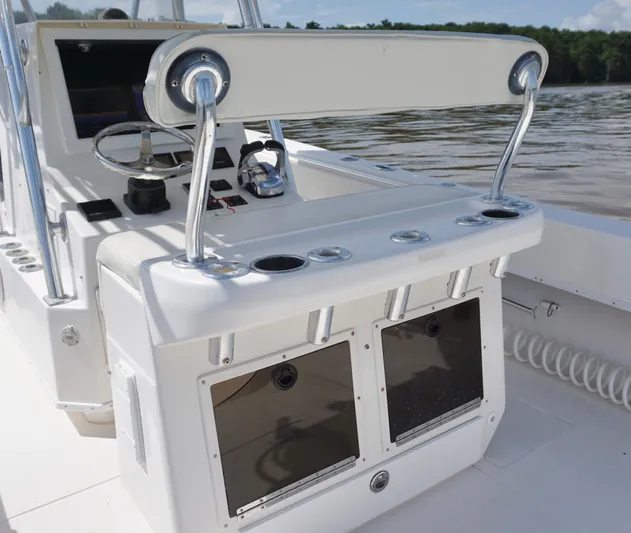  Yacht Photos Pics 2003 Contender 31 Open boat console with steering wheel and rod holders.