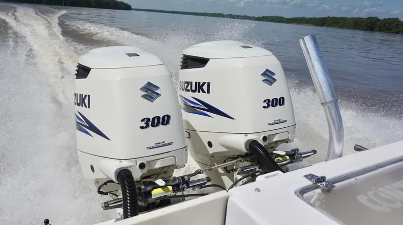  Yacht Photos Pics Twin Suzuki 300 outboard engines powering a 2003 Contender 31 Open boat on a lake.