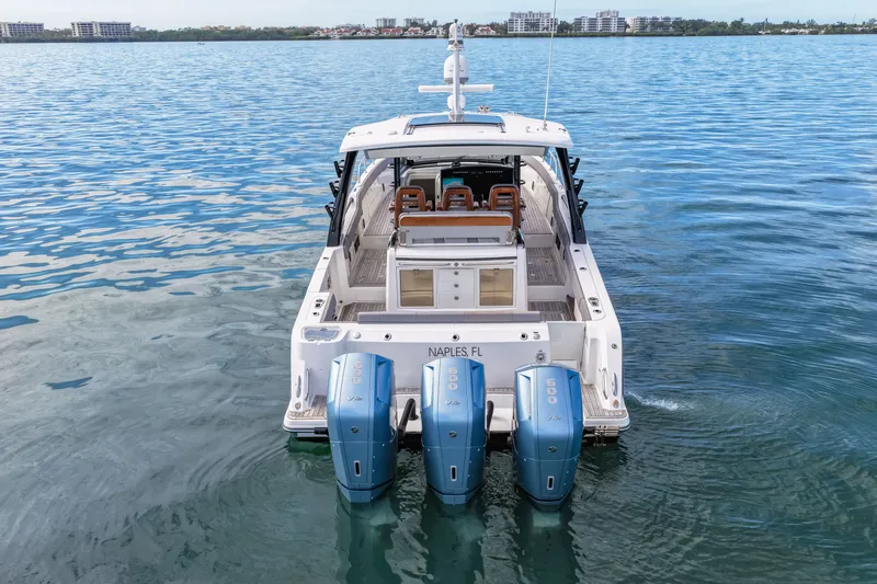  Yacht Photos Pics Boston Whaler 420 Outrage 2023 with triple outboard engines on calm water.