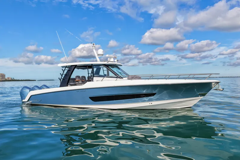  Yacht Photos Pics Boston Whaler 420 Outrage 2023 on calm water under blue sky.