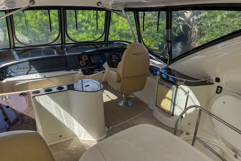  Yacht Photos Pics Interior of a 2015 Meridian 441 Sedan yacht, featuring a modern helm and seating area.