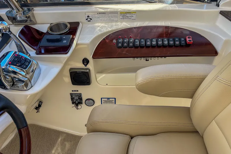  Yacht Photos Pics 2015 Meridian 441 Sedan helm with controls, switches, and beige seating.