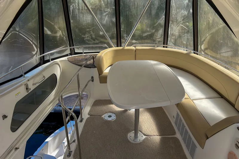  Yacht Photos Pics Interior of 2015 Meridian 441 Sedan yacht with beige seating and table.