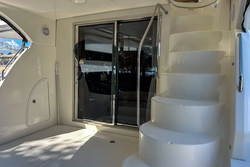  Yacht Photos Pics Interior view of 2015 Meridian 441 Sedan yacht with spiral staircase and sliding glass door.
