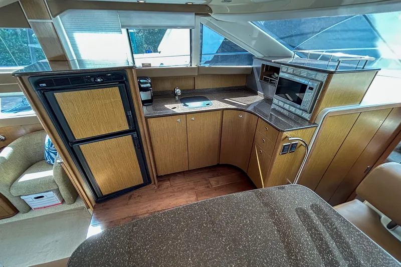  Yacht Photos Pics Luxurious 2015 Meridian 441 Sedan yacht kitchen with modern appliances and wood cabinetry.