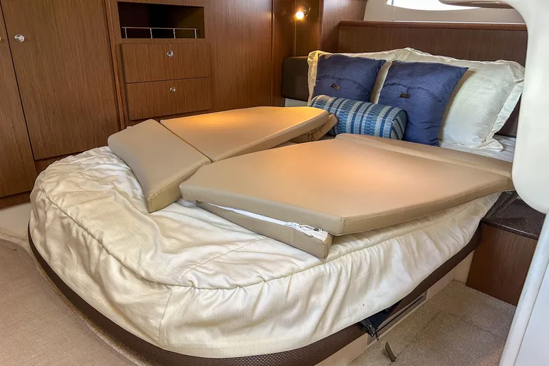  Yacht Photos Pics Luxurious cabin interior of 2015 Meridian 441 Sedan with plush bedding and cushions.