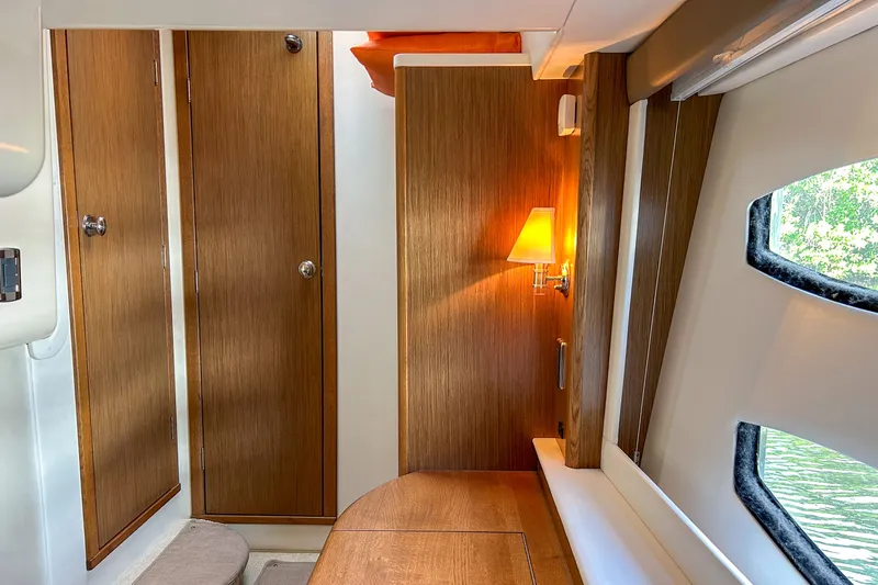  Yacht Photos Pics Interior of 2015 Meridian 441 Sedan yacht with wooden paneling and window view.