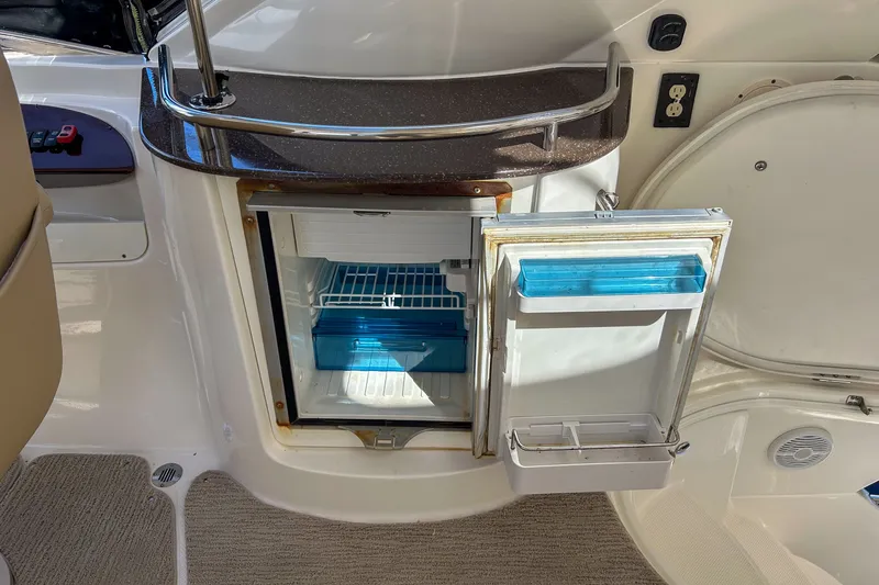  Yacht Photos Pics Open mini fridge on 2015 Meridian 441 Sedan yacht, showcasing interior storage.