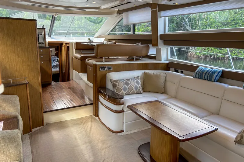  Yacht Photos Pics Luxurious interior of a 2015 Meridian 441 Sedan yacht with elegant seating and wood accents.
