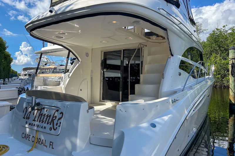  Yacht Photos Pics 2015 Meridian 441 Sedan yacht docked in Cape Coral, FL, featuring sleek design and spacious deck.