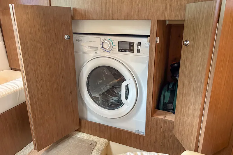  Yacht Photos Pics Built-in washing machine in 2015 Meridian 441 Sedan yacht, with wooden cabinetry.