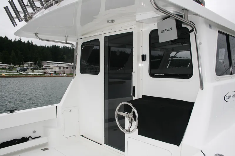 Catcher Yacht Photos Pics 2019 Ocean Sport Roamer 30 boat with Garmin equipment, docked near a marina.