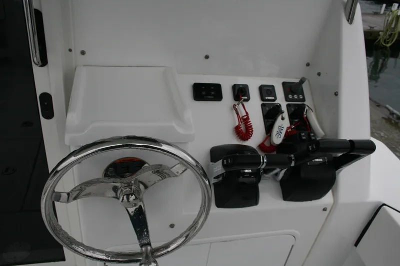 Catcher Yacht Photos Pics Control panel of 2019 Ocean Sport Roamer 30 #117 with steering wheel and controls.