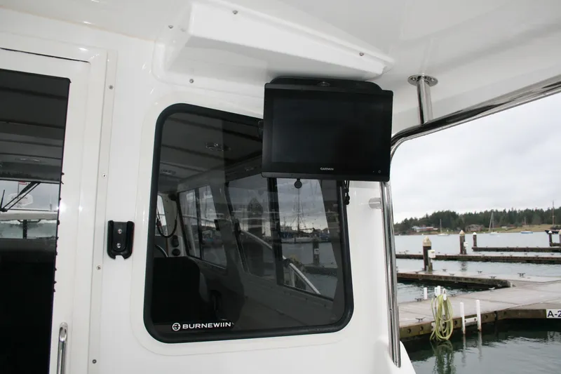 Catcher Yacht Photos Pics Interior view of 2019 Ocean Sport Roamer 30 #117 with Garmin display and marina backdrop.