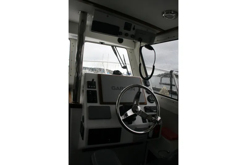 Catcher Yacht Photos Pics Interior view of 2019 Ocean Sport Roamer 30 #117 boat cockpit with steering wheel.