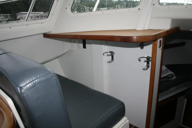 Catcher Yacht Photos Pics Interior of 2019 Ocean Sport Roamer 30, featuring seating and wooden cabinetry.