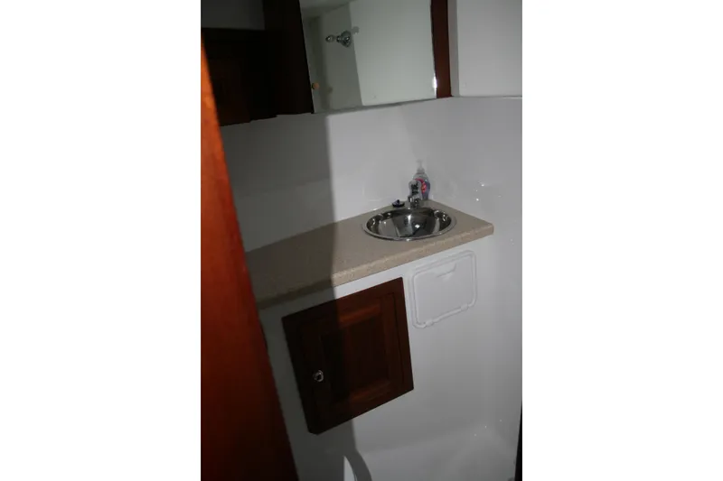 Catcher Yacht Photos Pics Interior of 2019 Ocean Sport Roamer 30, featuring a compact sink and wooden cabinetry.