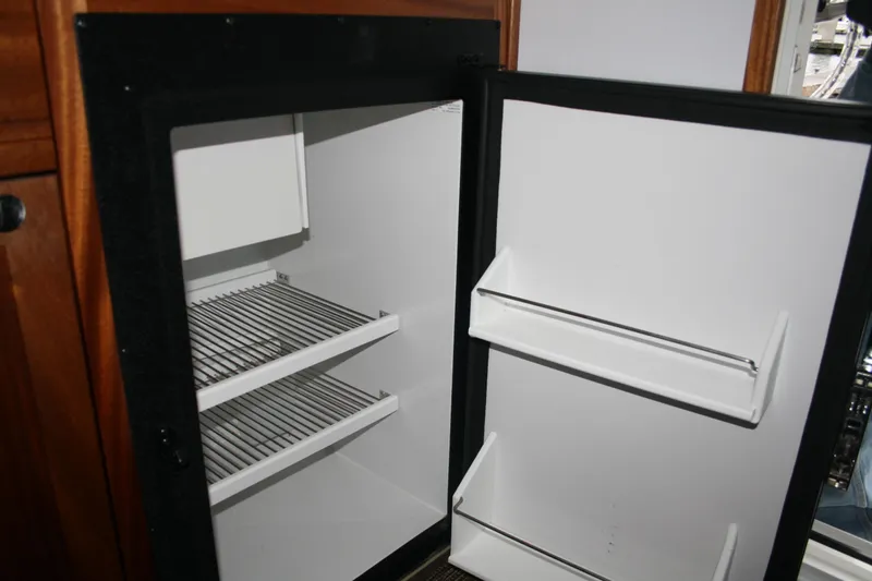 Catcher Yacht Photos Pics Open refrigerator inside 2019 Ocean Sport Roamer 30 #117 boat, showing shelves and door storage.