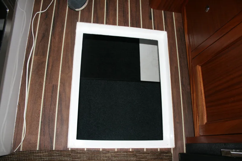 Catcher Yacht Photos Pics 2019 Ocean Sport Roamer 30 #117 interior with wood flooring and storage hatch.