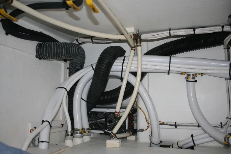 Catcher Yacht Photos Pics Engine compartment of 2019 Ocean Sport Roamer 30, showcasing organized hoses and wiring.