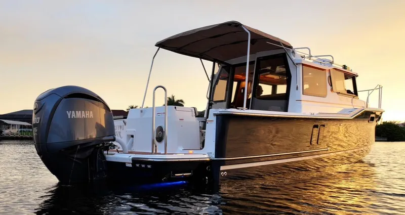  Yacht Photos Pics 2022 Ranger Tugs R-27 boat with Yamaha engine at sunset on the water.