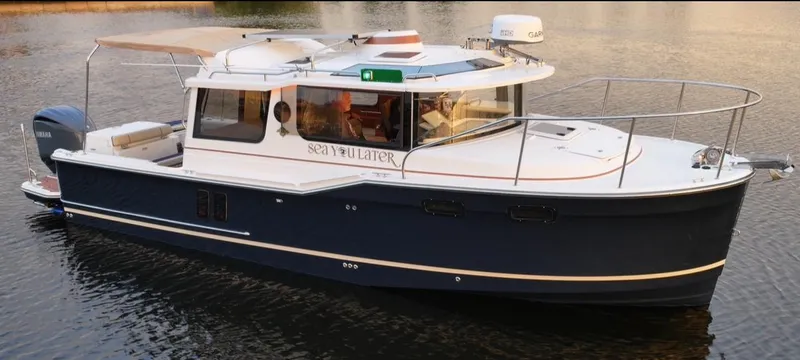  Yacht Photos Pics 2022 Ranger Tugs R-27 boat on calm water, featuring a sleek design and modern amenities.