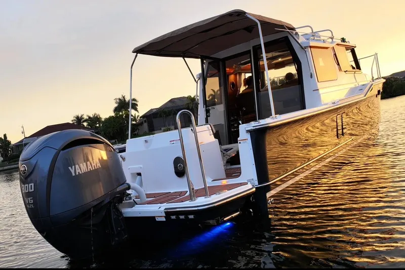  Yacht Photos Pics 2022 Ranger Tugs R-27 boat with Yamaha engine at sunset on the water.