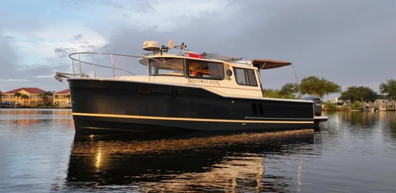  Yacht Photos Pics 2022 Ranger Tugs R-27 boat on calm water at sunset.