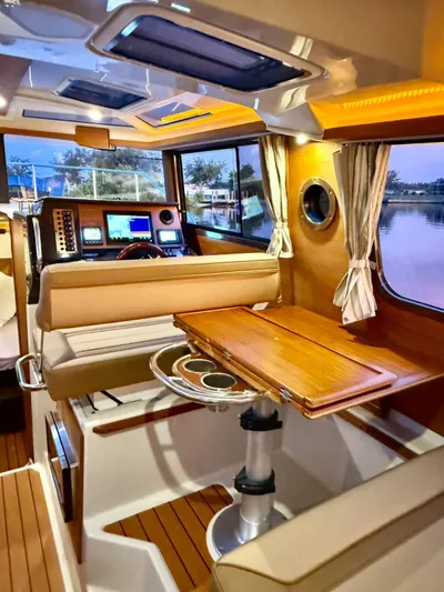  Yacht Photos Pics Interior of 2022 Ranger Tugs R-27 boat with elegant seating and navigation equipment.