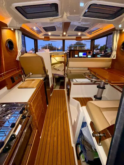  Yacht Photos Pics Interior of 2022 Ranger Tugs R-27 boat with wood finish and modern amenities.