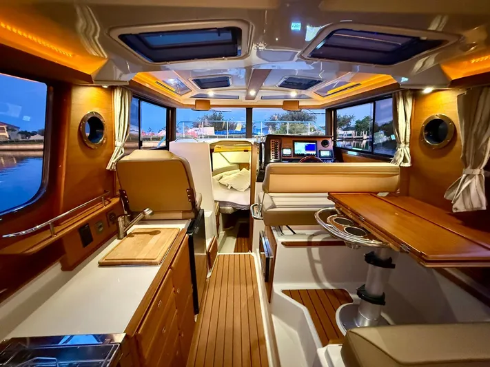  Yacht Photos Pics Interior of 2022 Ranger Tugs R-27 boat, featuring elegant wood finishes and modern amenities.