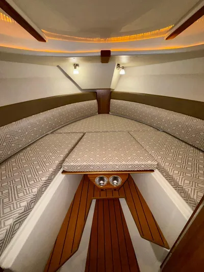  Yacht Photos Pics Interior of 2022 Ranger Tugs R-27 boat with patterned cushions and wood accents.