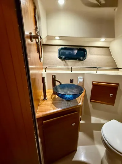  Yacht Photos Pics 2022 Ranger Tugs R-27 bathroom with modern sink and wooden cabinetry.