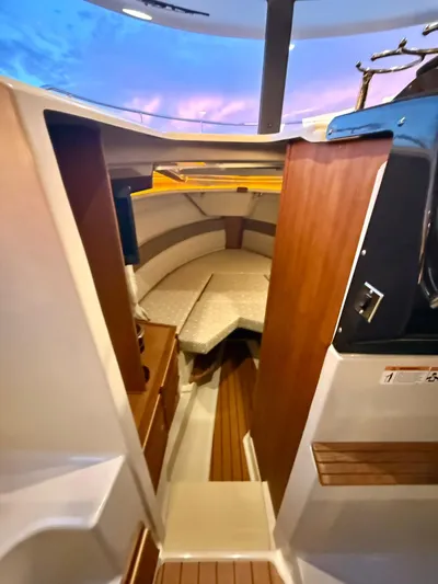  Yacht Photos Pics Interior cabin of 2022 Ranger Tugs R-27 boat with cozy seating and wooden accents.