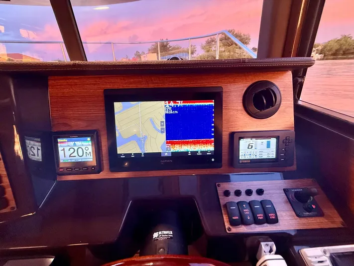  Yacht Photos Pics Dashboard of 2022 Ranger Tugs R-27 with navigation and control displays at sunset.