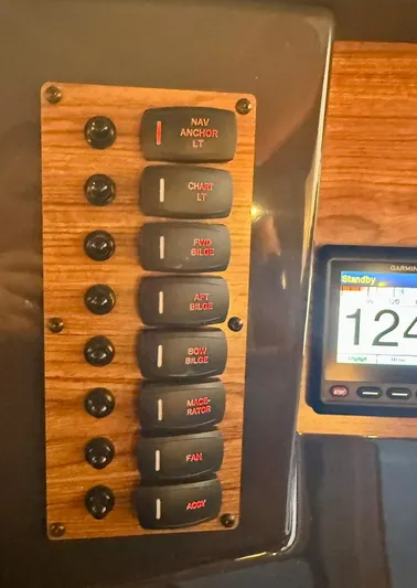  Yacht Photos Pics Control panel of a 2022 Ranger Tugs R-27 boat with labeled switches and display.