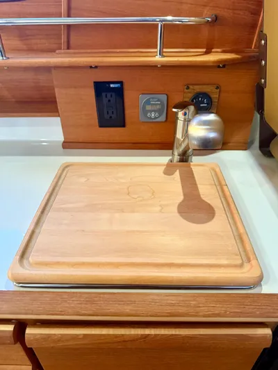  Yacht Photos Pics 2022 Ranger Tugs R-27 kitchen area with wooden cutting board and faucet.