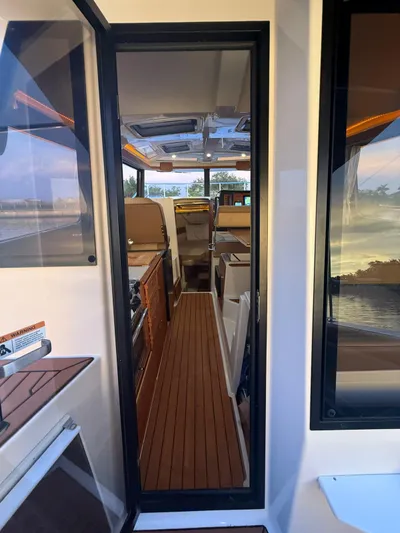  Yacht Photos Pics Interior view of 2022 Ranger Tugs R-27 boat, featuring sleek design and wood flooring.