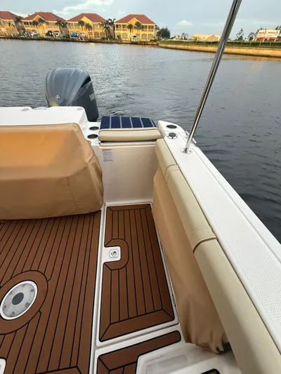  Yacht Photos Pics 2022 Ranger Tugs R-27 boat deck with wood finish, docked near waterfront homes.