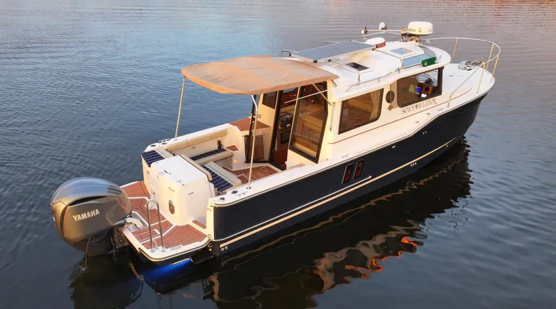  Yacht Photos Pics 2022 Ranger Tugs R-27 boat on calm water, featuring Yamaha outboard motor.