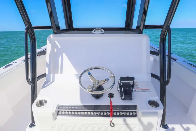  Yacht Photos Pics 2025 Invincible 35 Catamaran helm with steering wheel, controls, and ocean view.