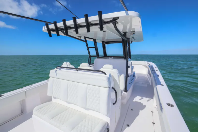  Yacht Photos Pics 2025 Invincible 35 Catamaran on open sea, featuring sleek white seating and modern design.