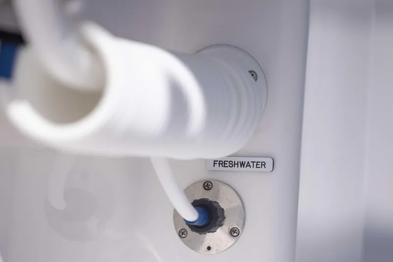  Yacht Photos Pics Freshwater connection on 2025 Invincible 35 Catamaran, featuring white hose and labeled port.