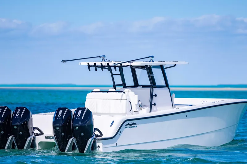  Yacht Photos Pics 2025 Invincible 35 Catamaran on clear blue water, featuring powerful outboard engines.