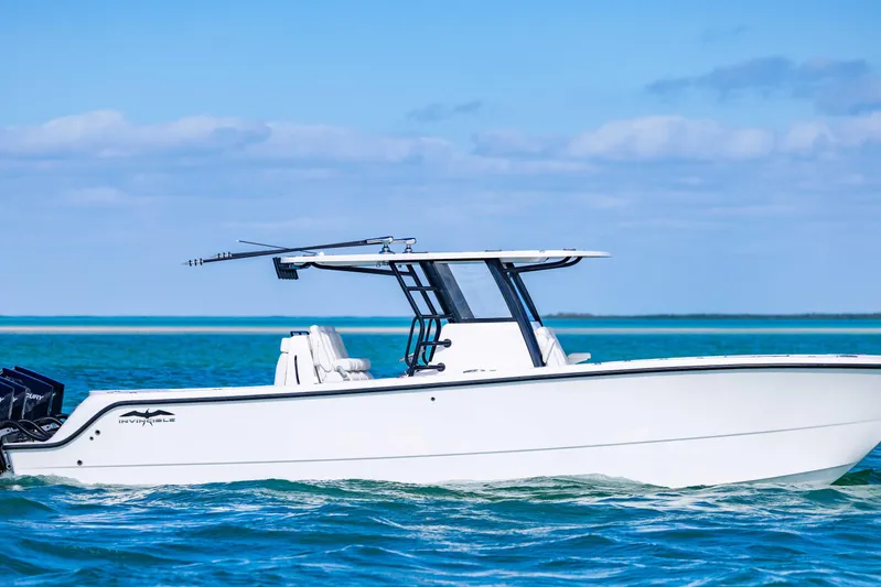  Yacht Photos Pics 2025 Invincible 35 Catamaran cruising on clear blue waters under a sunny sky.