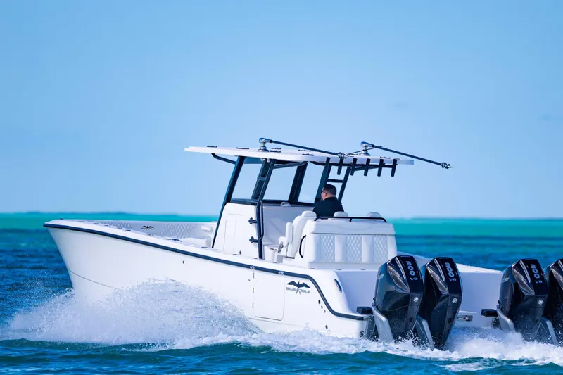  Yacht Photos Pics 2025 Invincible 35 Catamaran cruising on clear blue ocean waters.