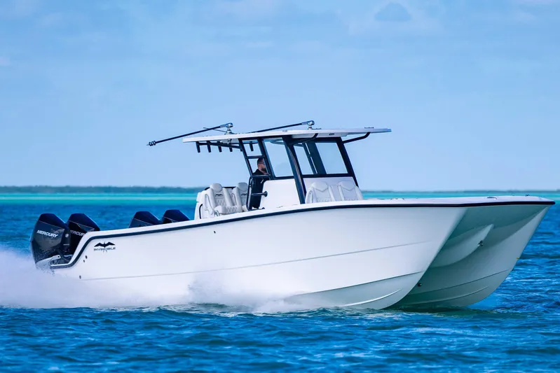 Yacht Photos Pics 2025 Invincible 35 Catamaran cruising on blue ocean waters.