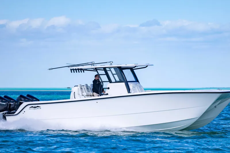  Yacht Photos Pics 2025 Invincible 35 Catamaran cruising on blue ocean waters.